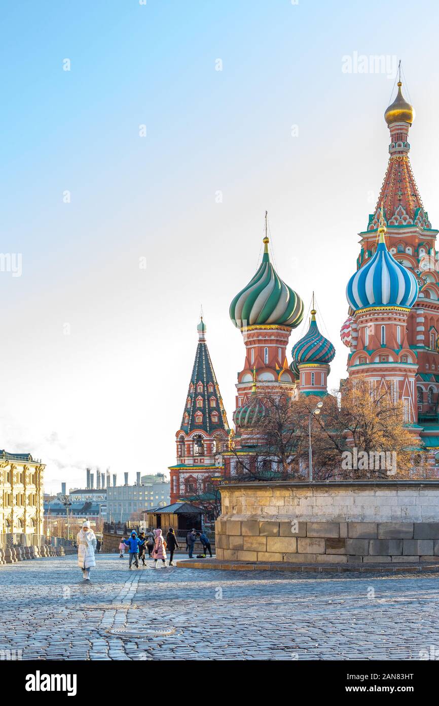 Moscow, Russia - December 1, 2019: St Basil Cathedral on Red Square, a popular tourist landmark. Vertical bright photo, clear blue sky, funny tourists Stock Photo