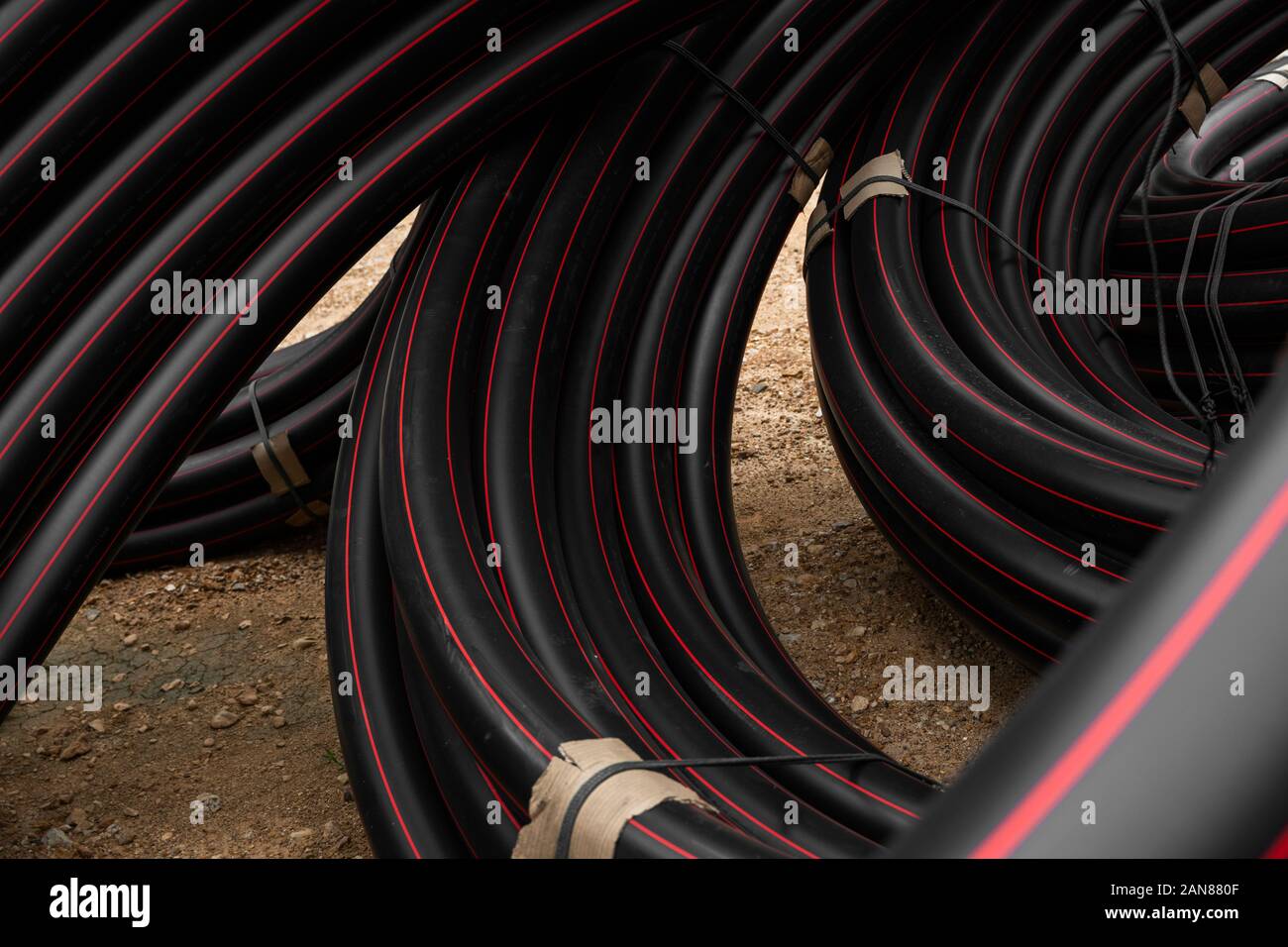 Pipe Red Line Black rubber or plastic pipes with a red lines as a construction ...