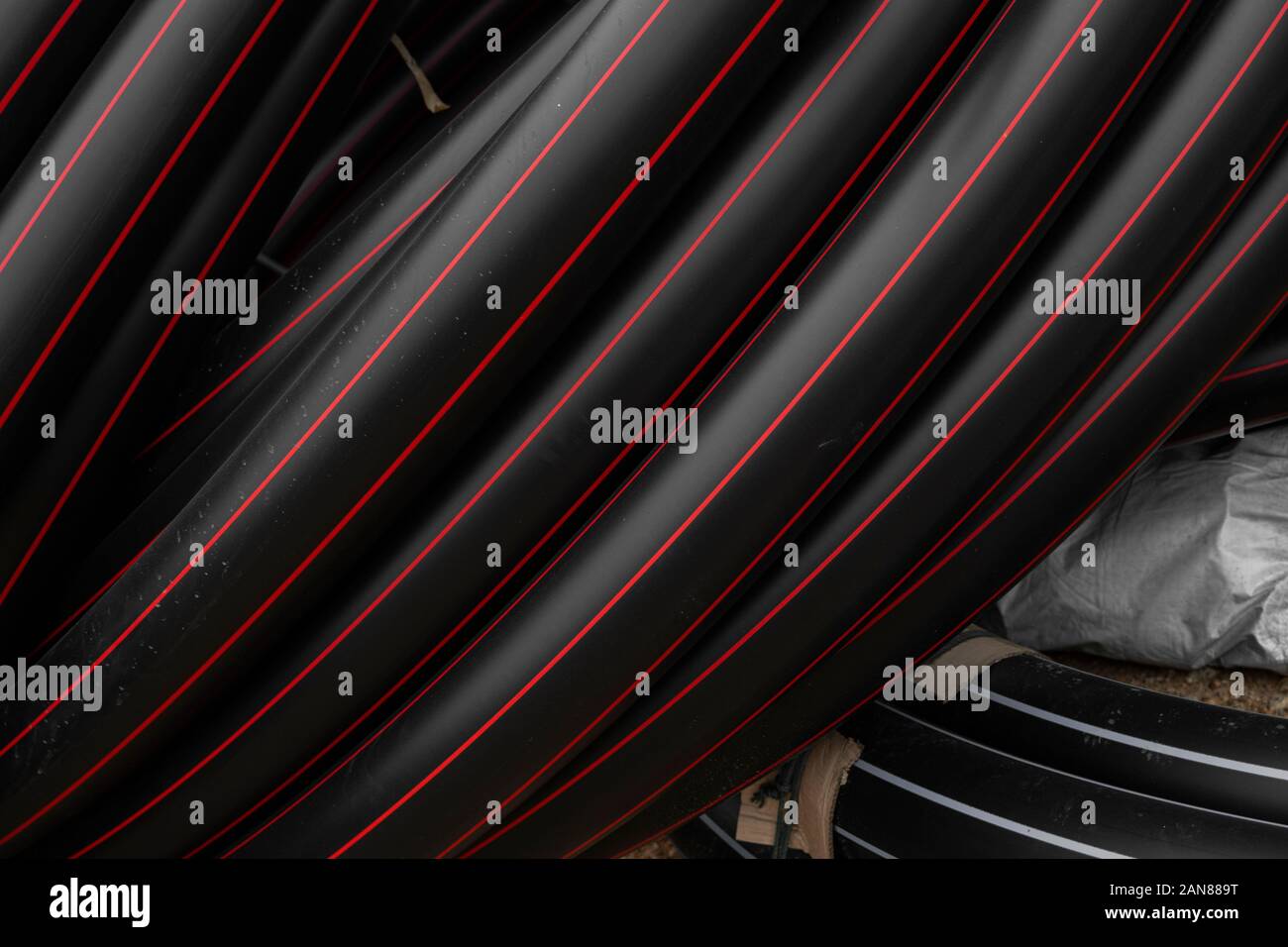 Pipe Red Line Black rubber or plastic pipes with a red lines as a construction ...