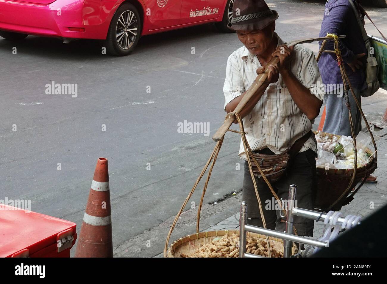 Close up of man with carrying pole in Bangkok, Thailand Stock Photo