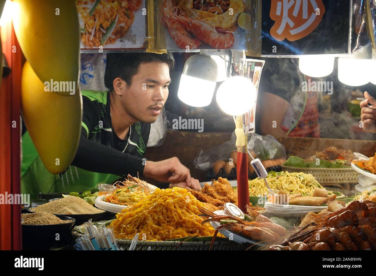 Street food vendor preparing his sale stall. Stock Photo
