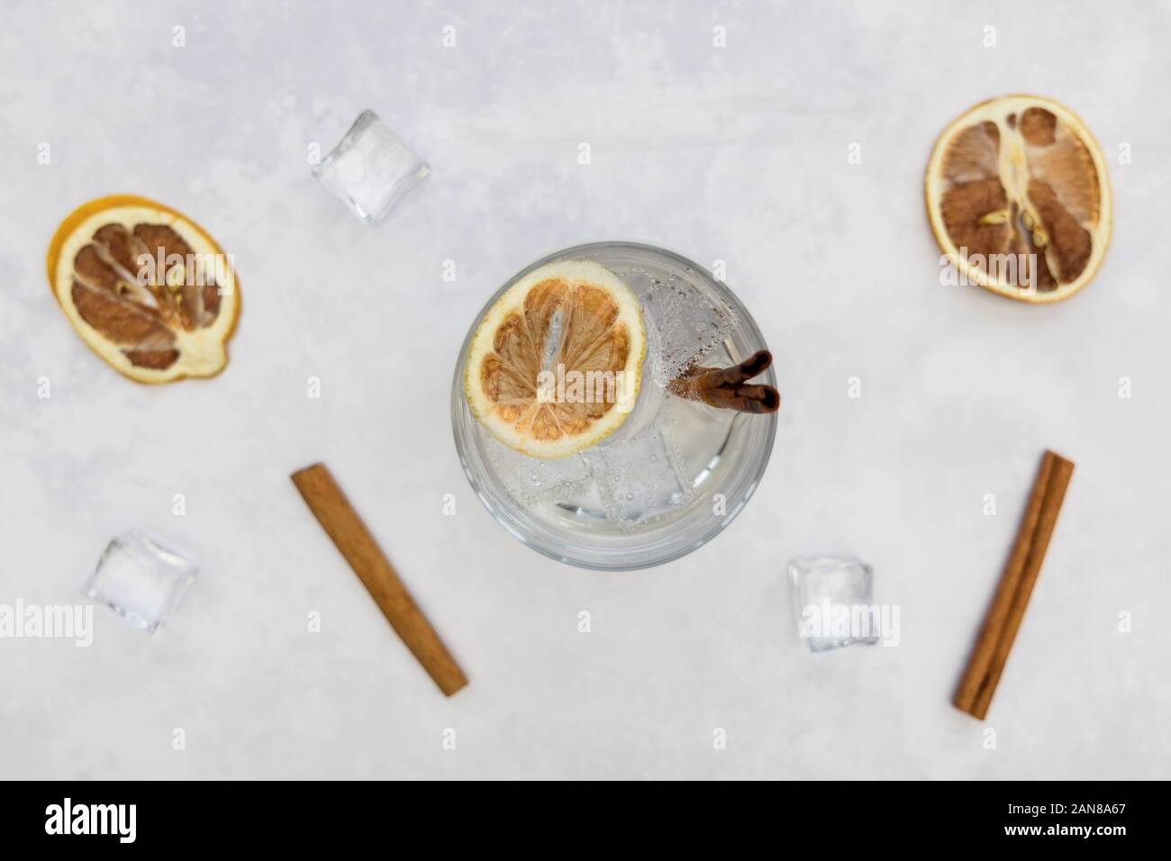 Gin tonic vodka soda cocktail drink in glass with ice cinnamon, top view on white background