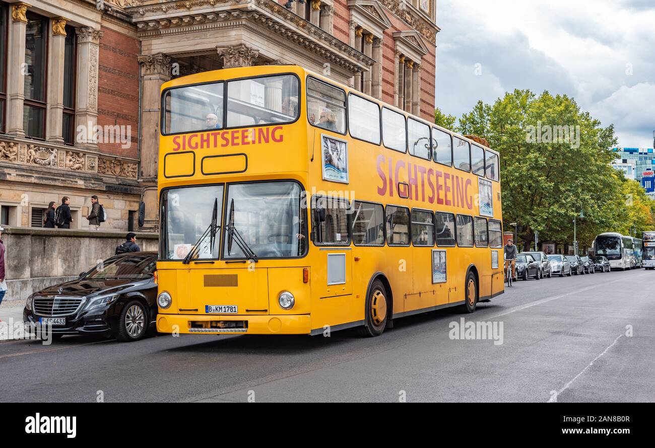 Yellow sightseeing bus on the city streets in Berlin, Germany Stock ...