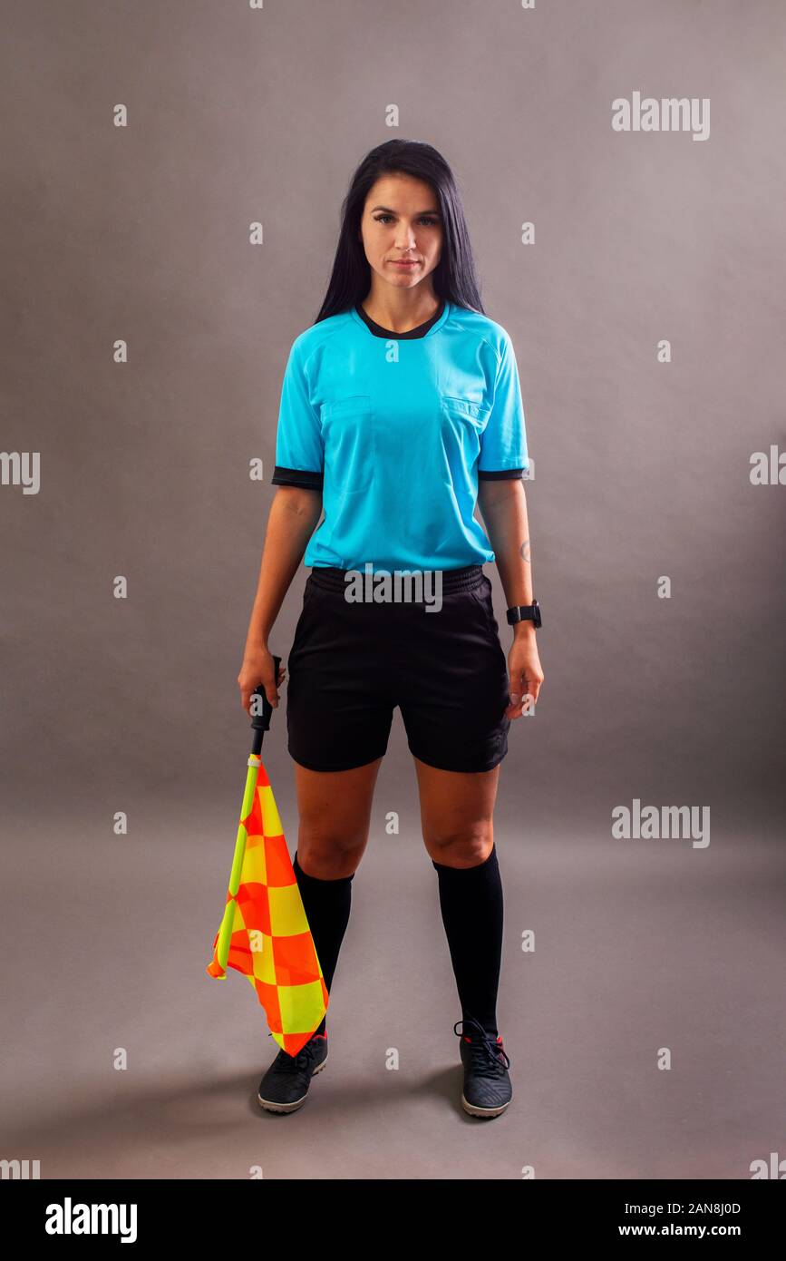 Beautiful Soccer Referee with flag in hand looking at camera and smile Stock Photo