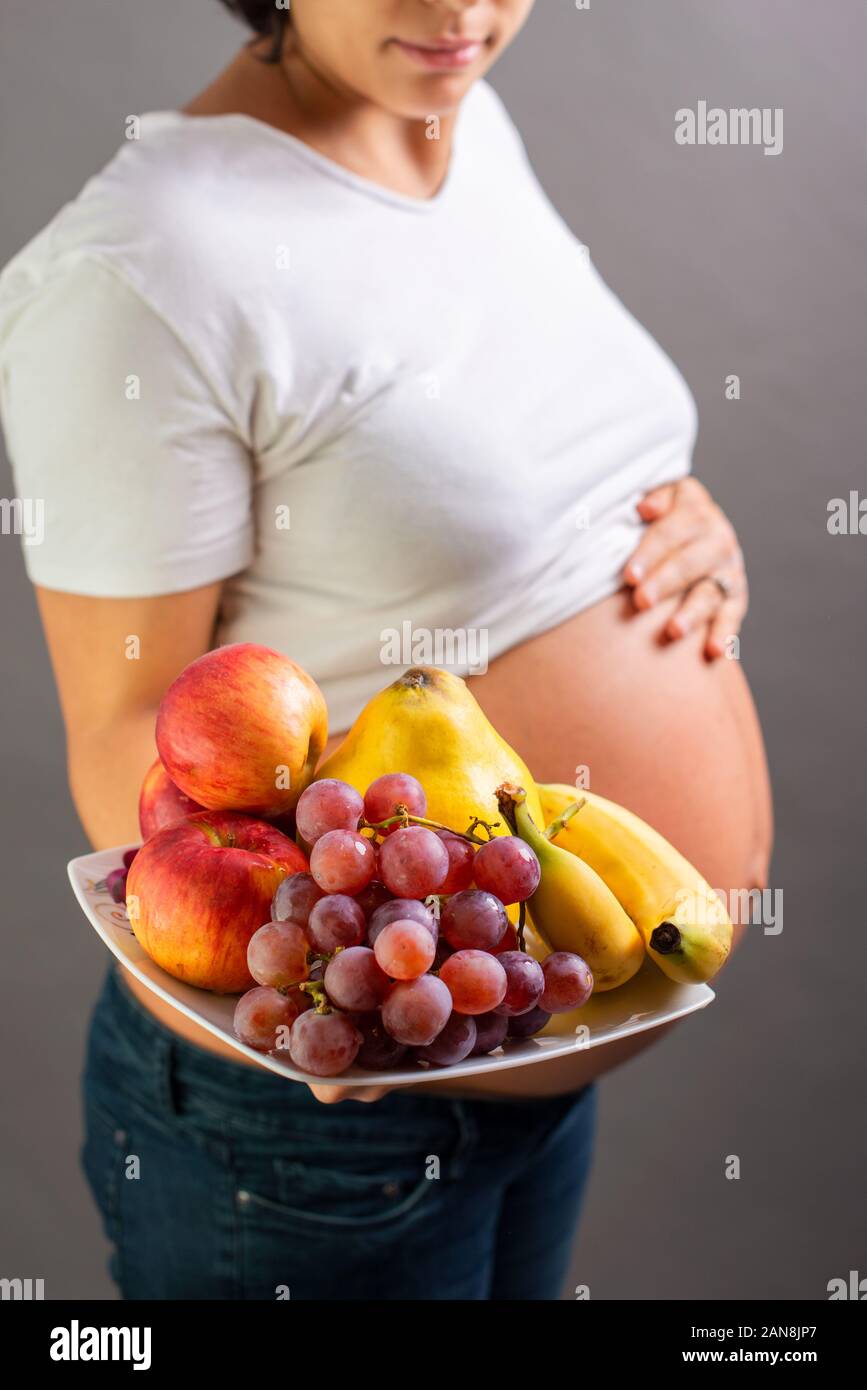 Pregnancy and nutrition diet pregnant woman with fruits. Studio shoot