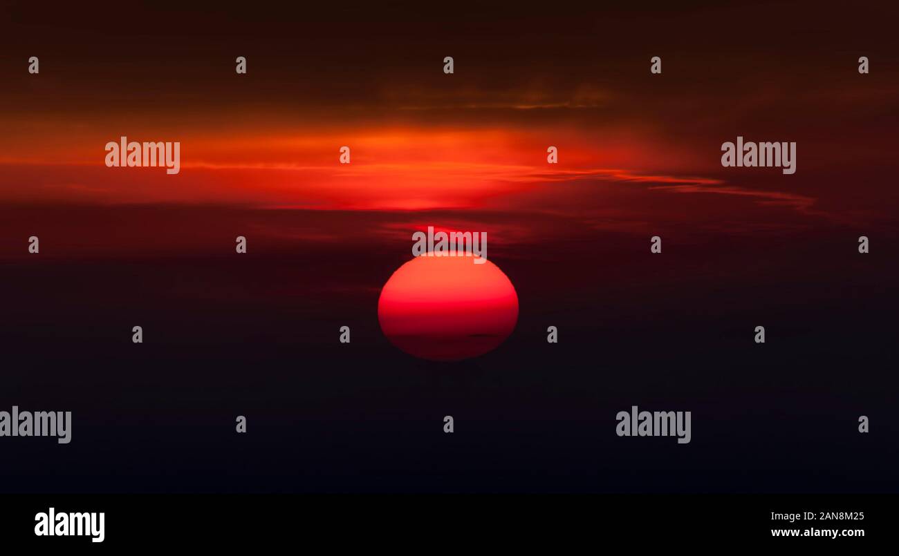 sun and sunset sky with red clouds Stock Photo - Alamy