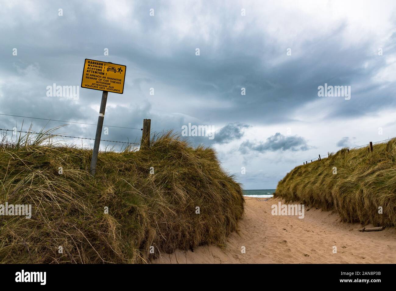Beware of car thieves warning sign on an isolated rual beach on the west coast of Ireland Stock Photo