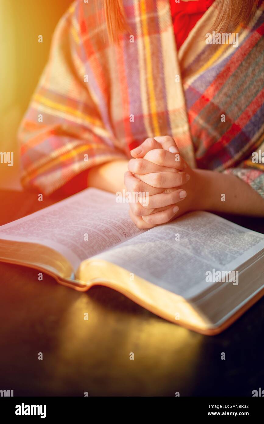 Beautiful woman praying having the Bible opened in front of he Stock Photo  - Alamy