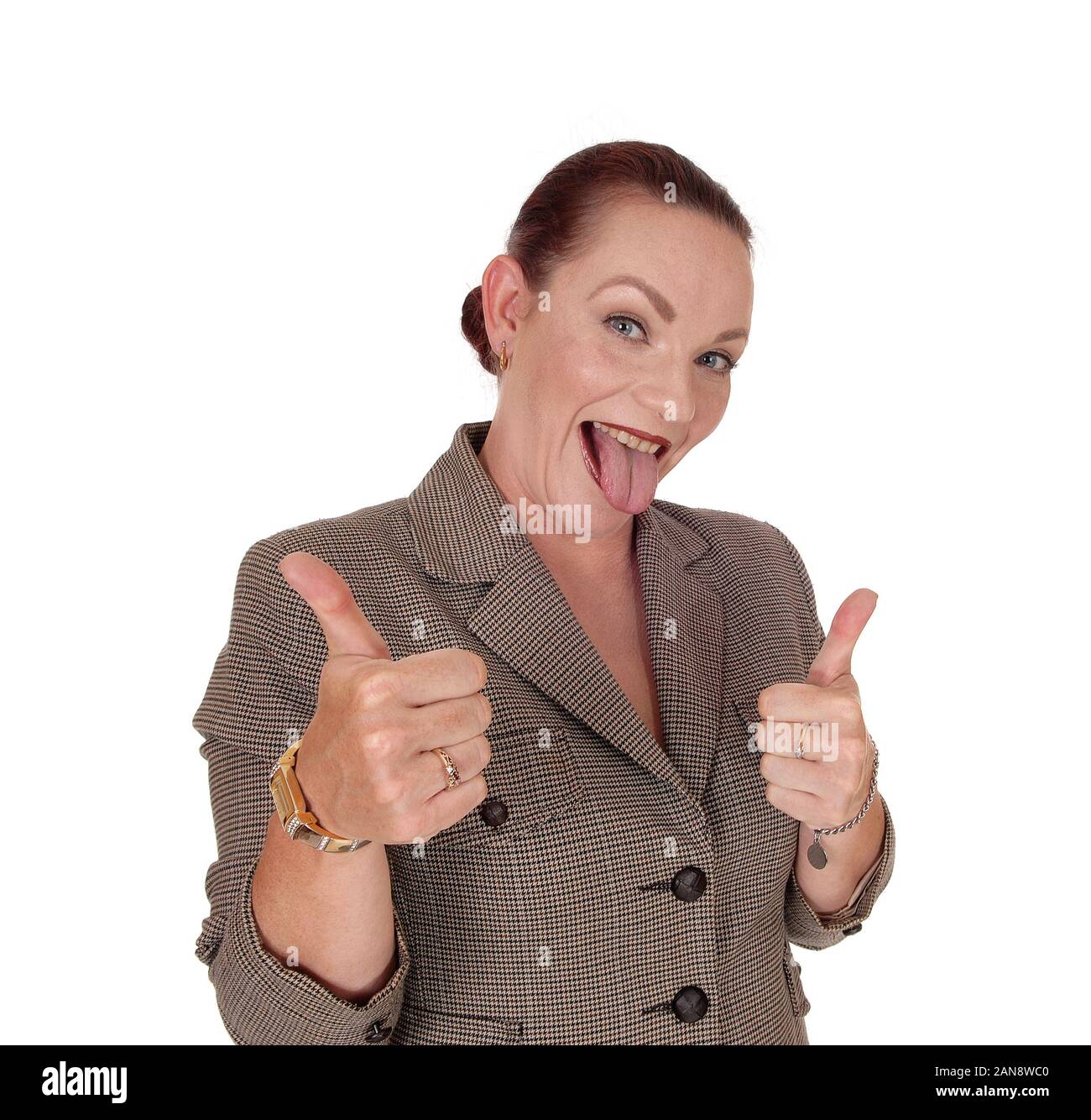 An happy businesswoman standing in a brown jacket gesturing thump up and approving, isolated for white background Stock Photo