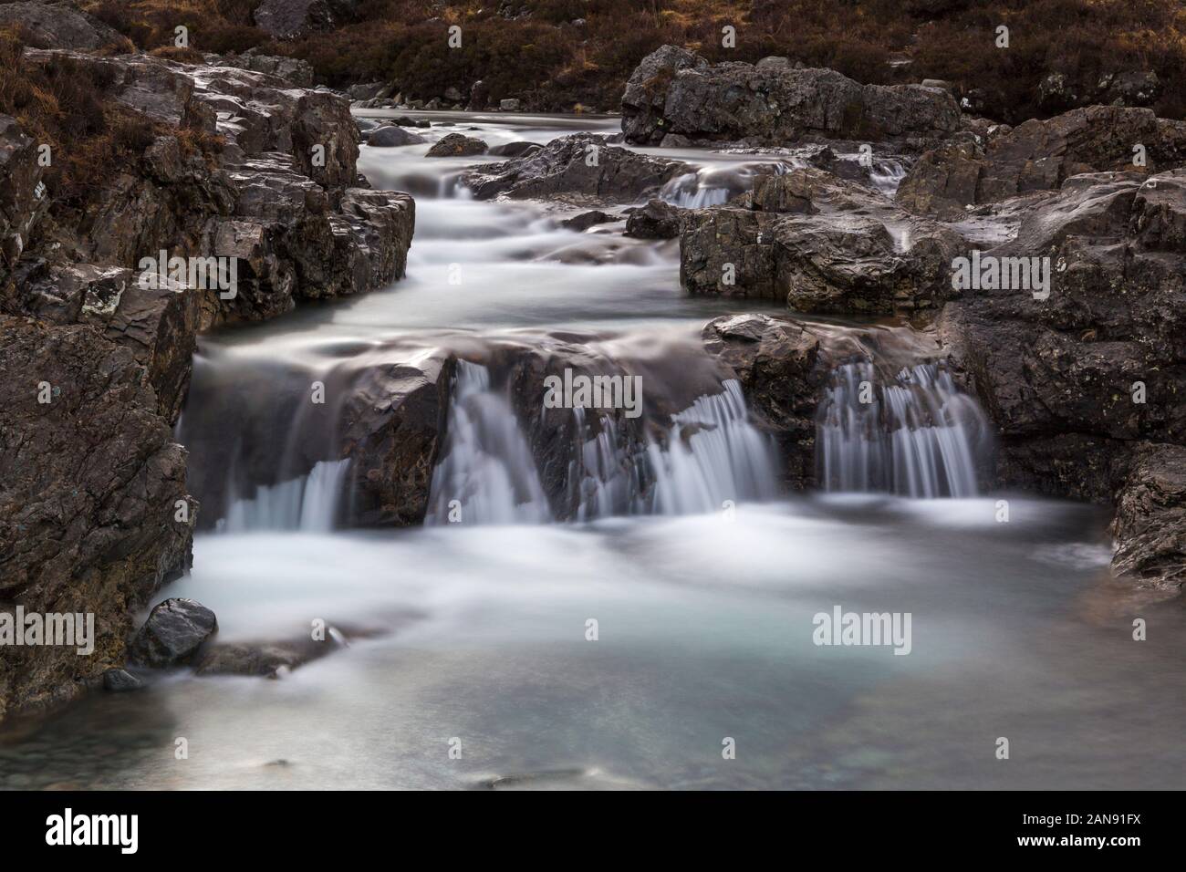 Fairy Pools with waterfalls at the river Brittle, Isle of Skye, Scotland, UK in March - long exposure Stock Photo