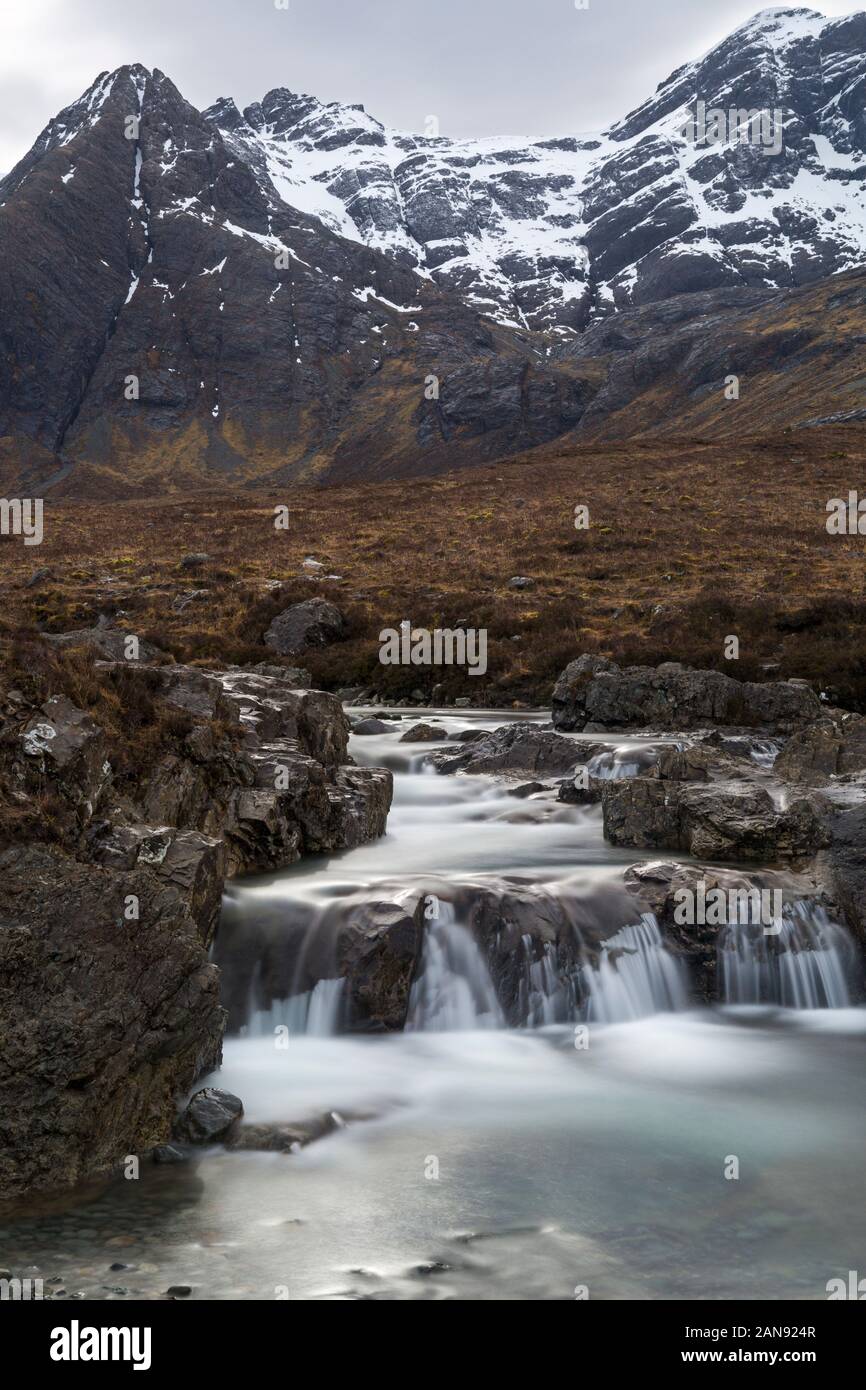 Fairy Pools with low cloud over the Black Cuillin mountains with waterfalls at the river Brittle, Isle of Skye, Scotland, UK in March - long exposure Stock Photo