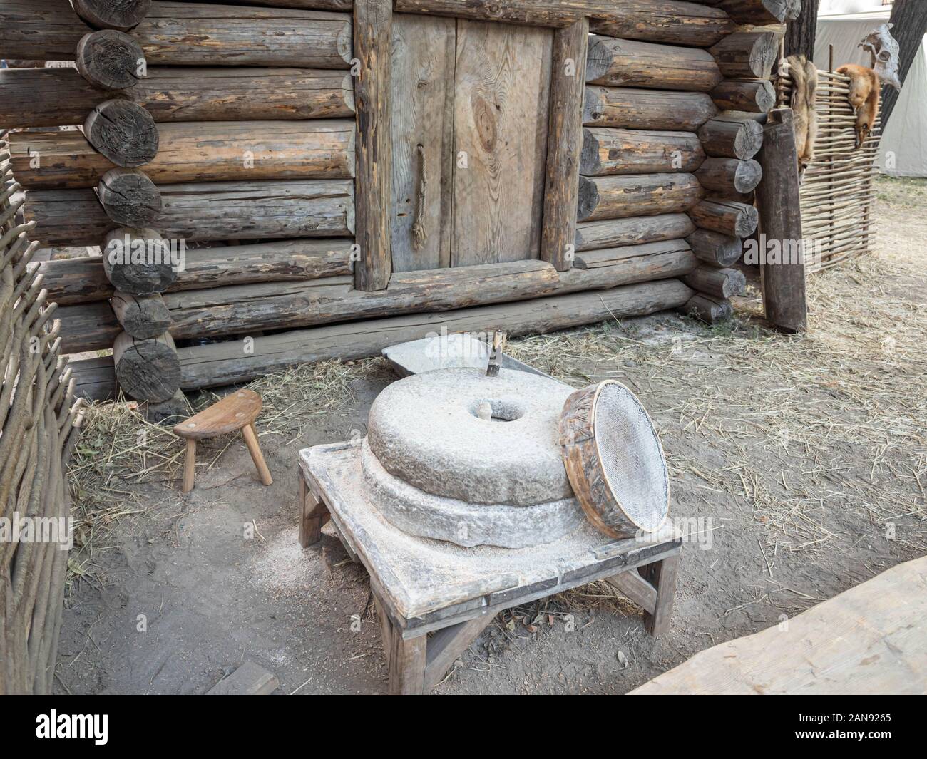 Rotary discoid mill stone for handgrinding a grain into flour