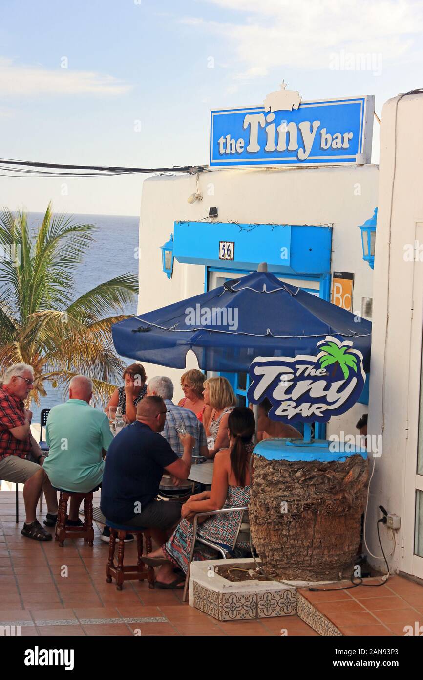 People sat outside The Tiny Bar, Puerto del Carmen, Lanzarote Stock Photo -  Alamy