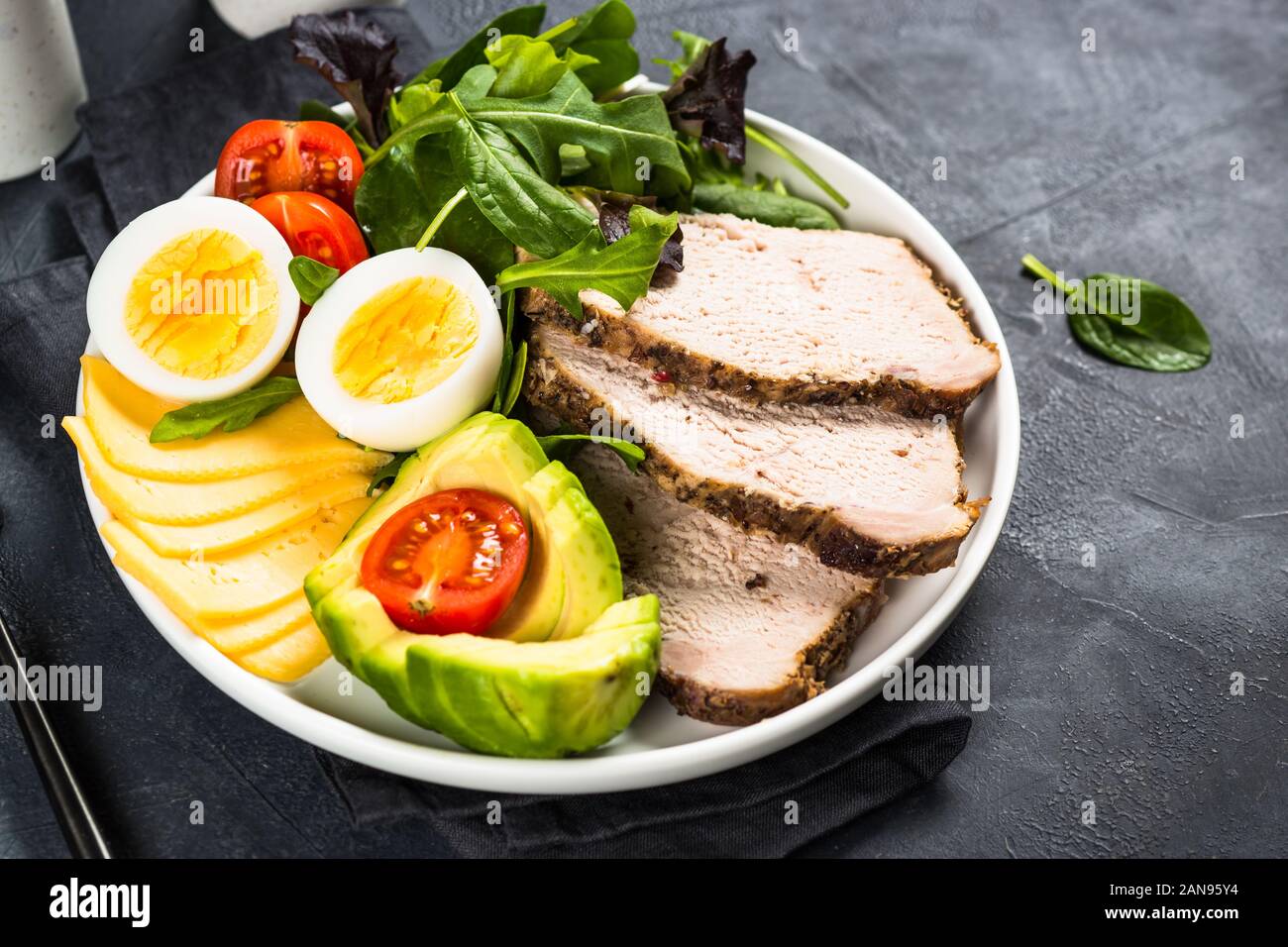 Keto diet plate on black stone table Stock Photo - Alamy