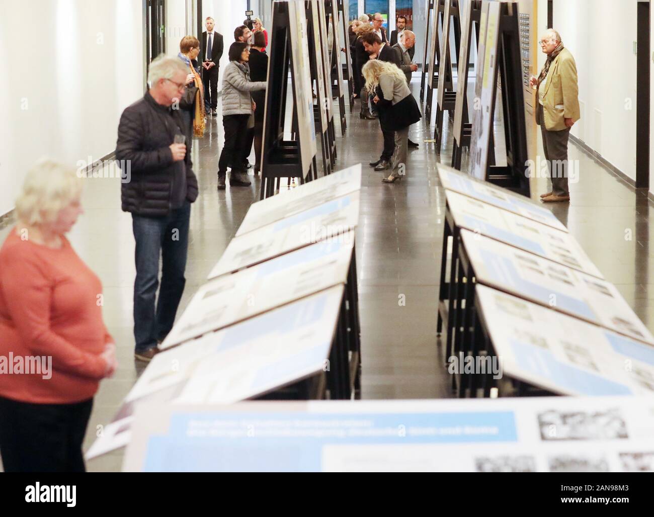 Erfurt, Germany. 16th Jan, 2020. Spectators view exhibition panels at the opening of the exhibition 'Racial diagnosis: Gypsies' - The genocide of the Sinti and Roma and the long struggle for recognition. This is an exhibition of the Documentation and Cultural Centre of German Sinti and Roma. Credit: Bodo Schackow/dpa-Zentralbild/dpa/Alamy Live News Stock Photo