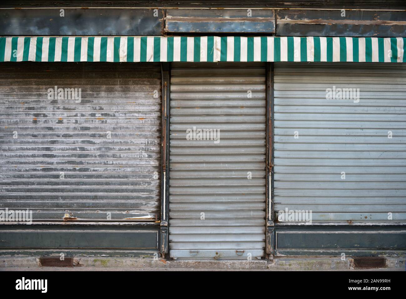 Ancient storefront with metallic closed curtains. Abandoned shop business  Stock Photo - Alamy