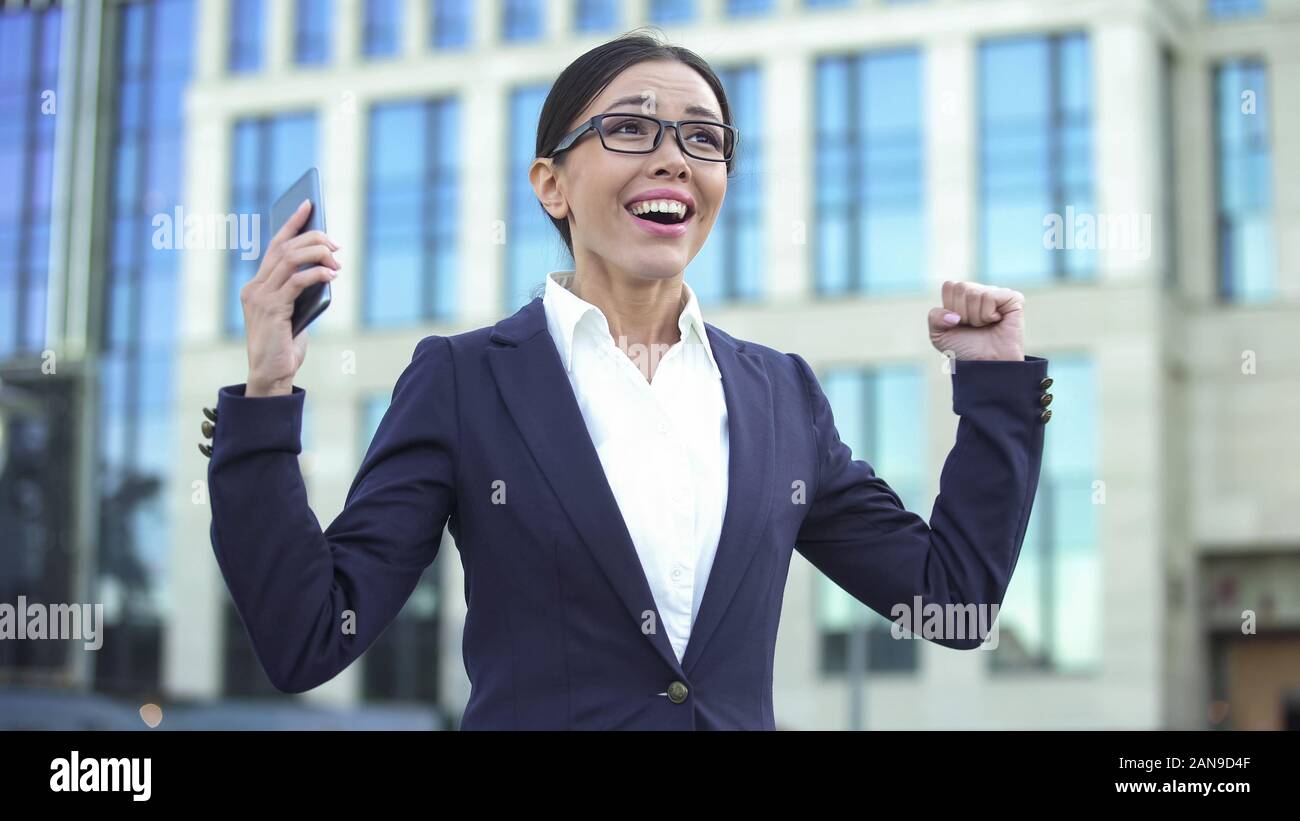 Happy young lady showing success sign, receiving job offer, successful startup Stock Photo Alamy