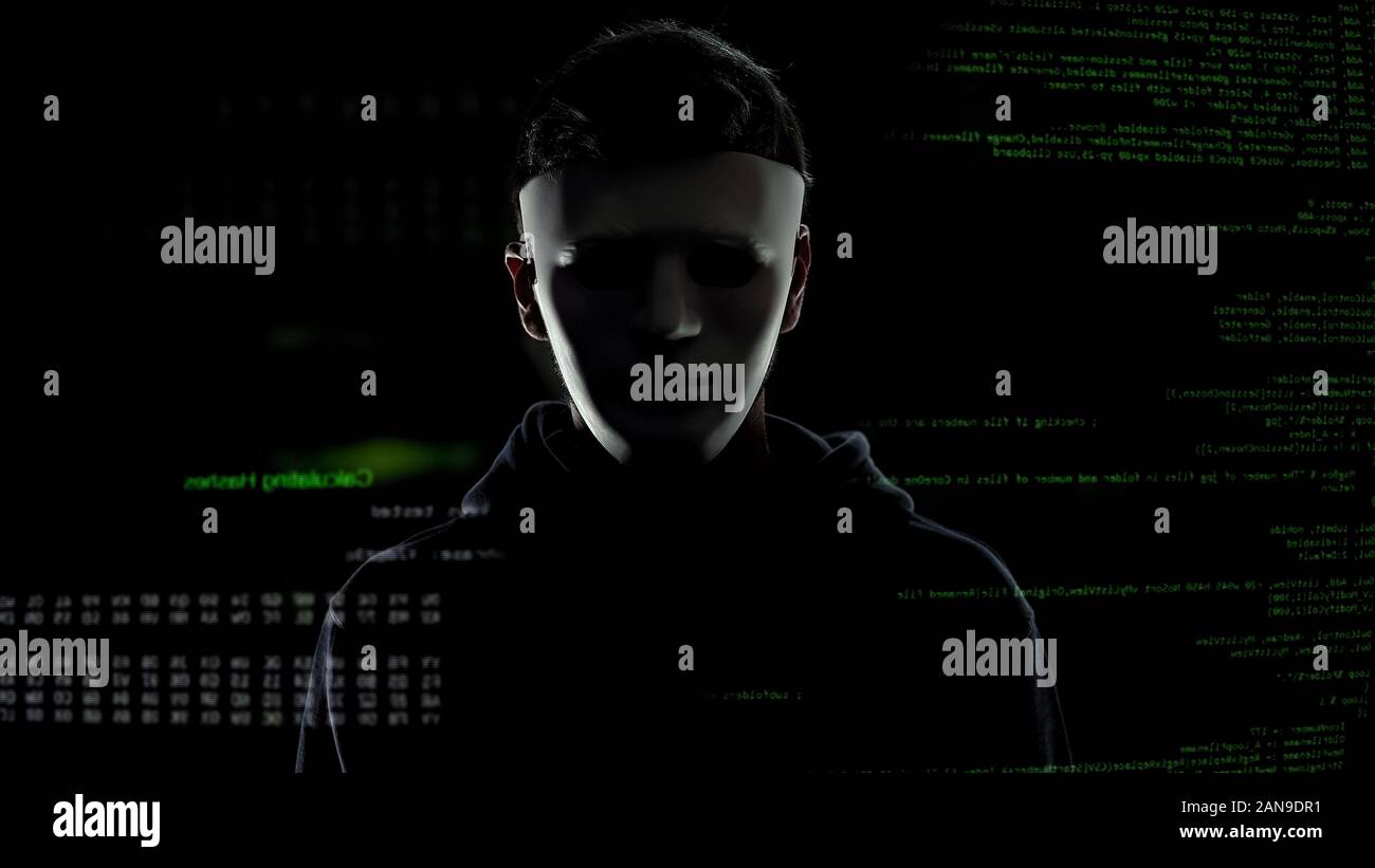 Dangerous man in white mask on codes and numbers background, hacking ...
