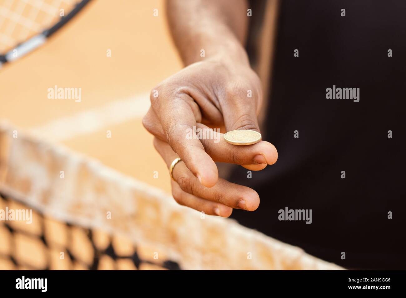 Close up of referee hands flipping a coin before starting the game or match. Stock Photo