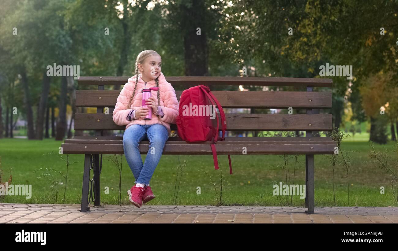 School girl sitting on bench hi-res stock photography and images - Alamy