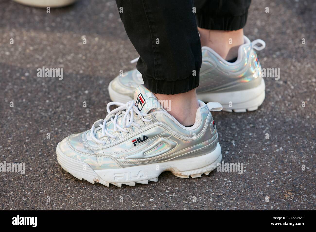 MILAN, ITALY - JANUARY 12, 2019: Woman with silver and white Fila sneakers  before Salvatore Ferragamo fashion show, Milan Fashion Week street style  Stock Photo - Alamy