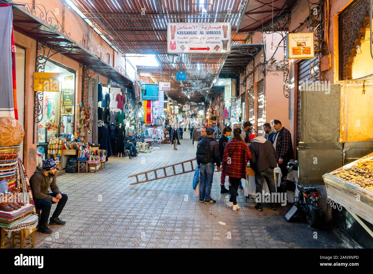 Marrakech, Morocco - January 7, 2020: Tourists buying stuff on market in medina of Marrakech Stock Photo
