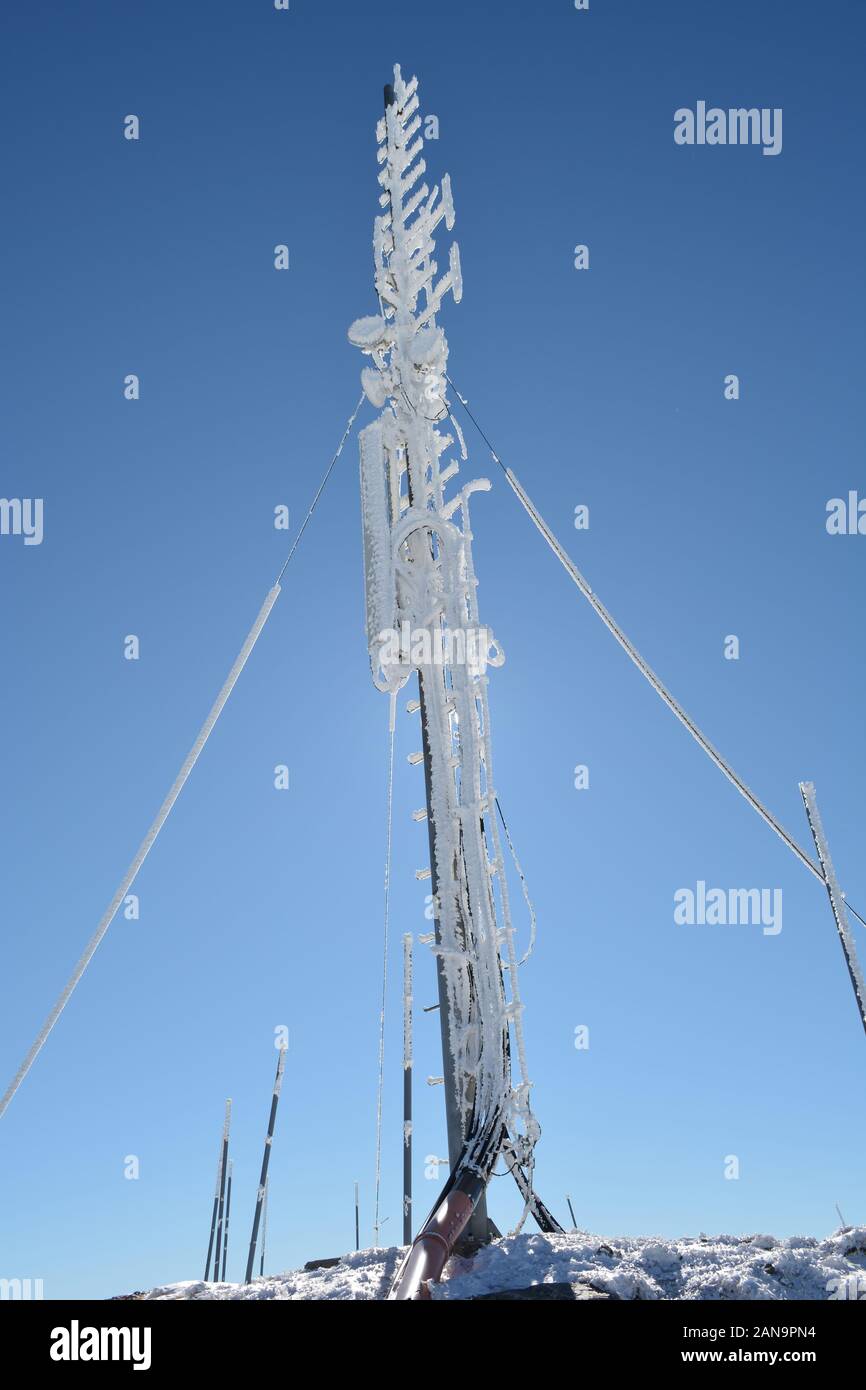 Frozen multi purpose antenna, covered by hoarfrost on the mountain peak