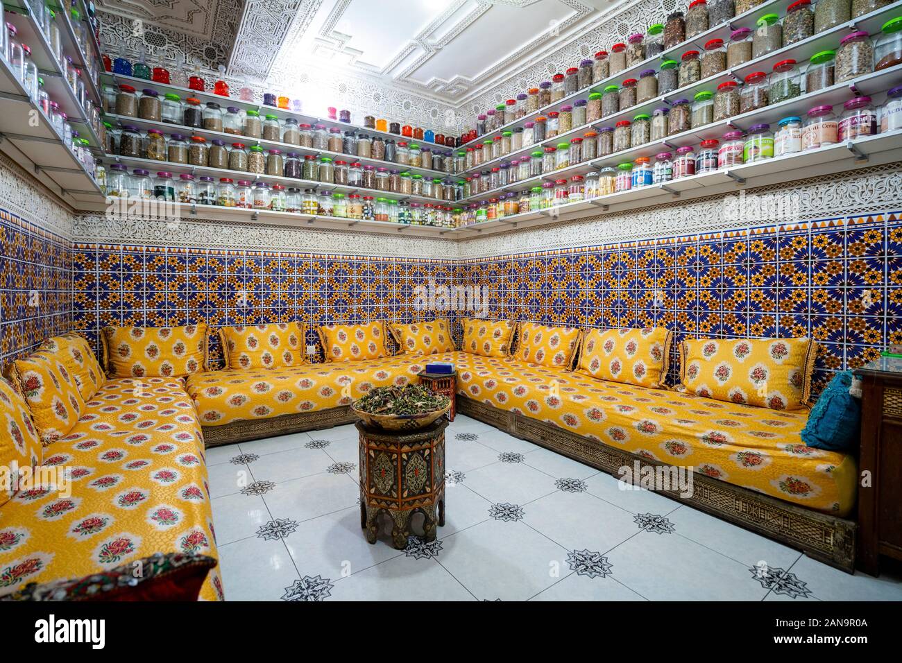 Moroccan interior with variety of spices on shelves and herbal tea in the middle of the room Stock Photo