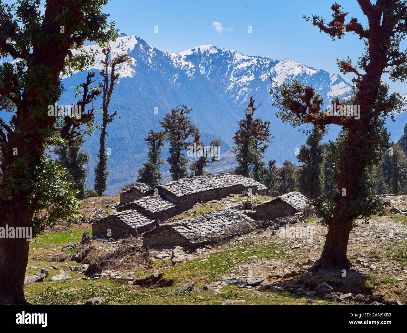 Shepherd huts high above the village of Supi in the Saryu Valley of the Uttarakhand Himalayas Northern India Stock Photo