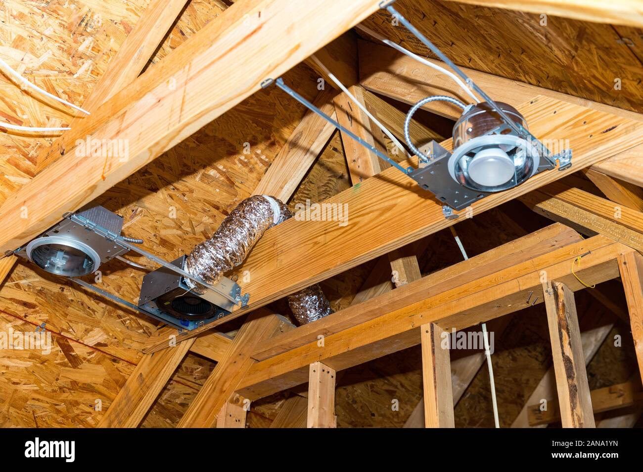 Electrical recessed can lights and vents during new construction Stock Photo