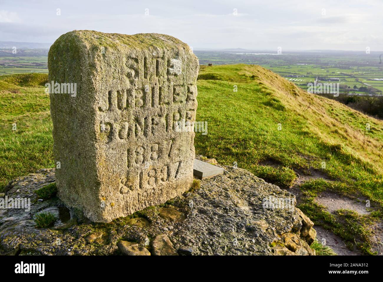 Jubillee Stone on the summit of Brent Knoll a carboniferous limestone outlier of the Mendips on the Somerset Levels UK Stock Photo