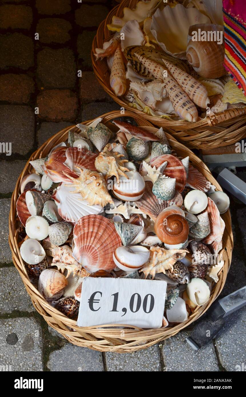 Various sea shells in a wicker basket at 1 euro cost Stock Photo