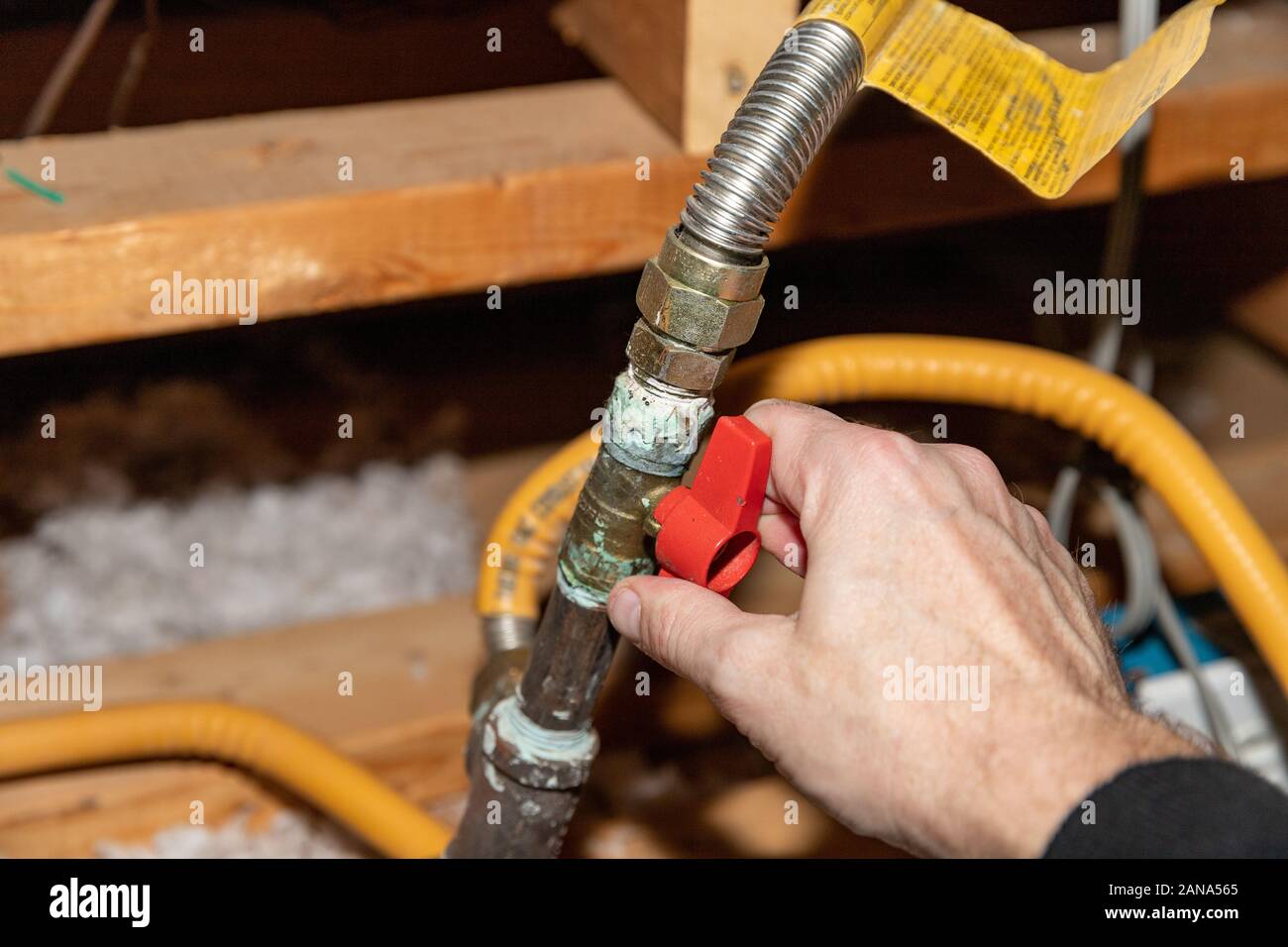 Hand turning safety shut off valve of a natural gas pipe Stock Photo