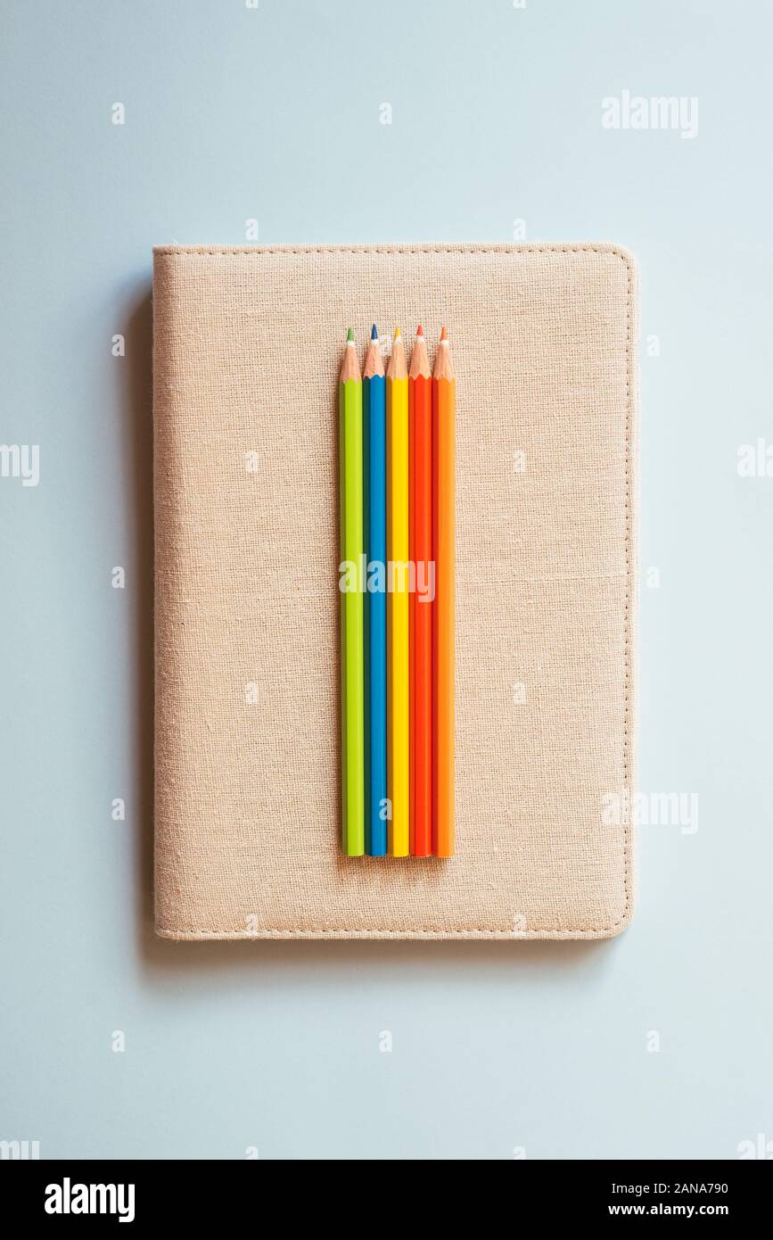 https://c8.alamy.com/comp/2ANA790/notebook-with-some-colored-pencils-2ANA790.jpg