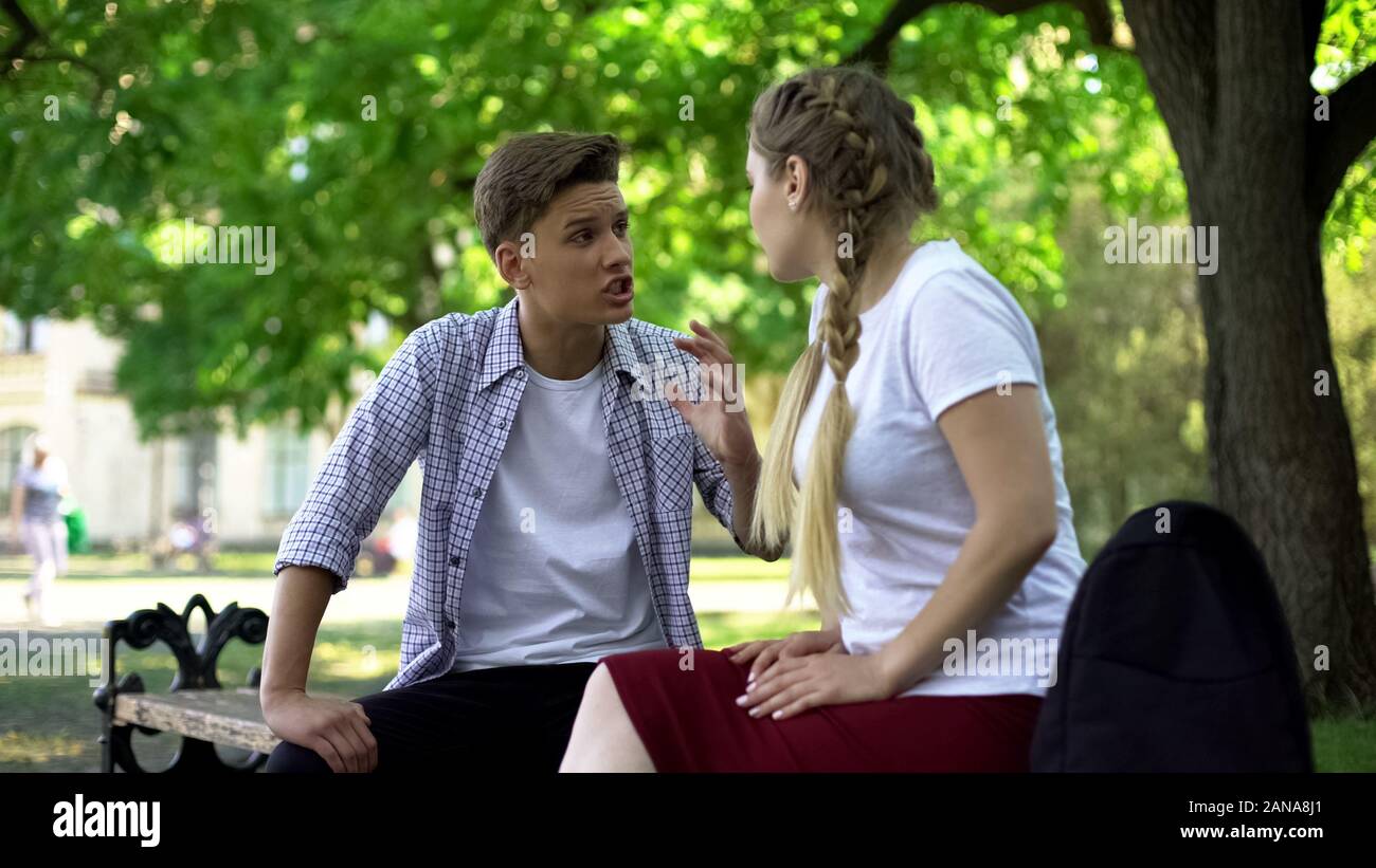 Teenagers arguing in park, break up because of misunderstanding, conflict Stock Photo