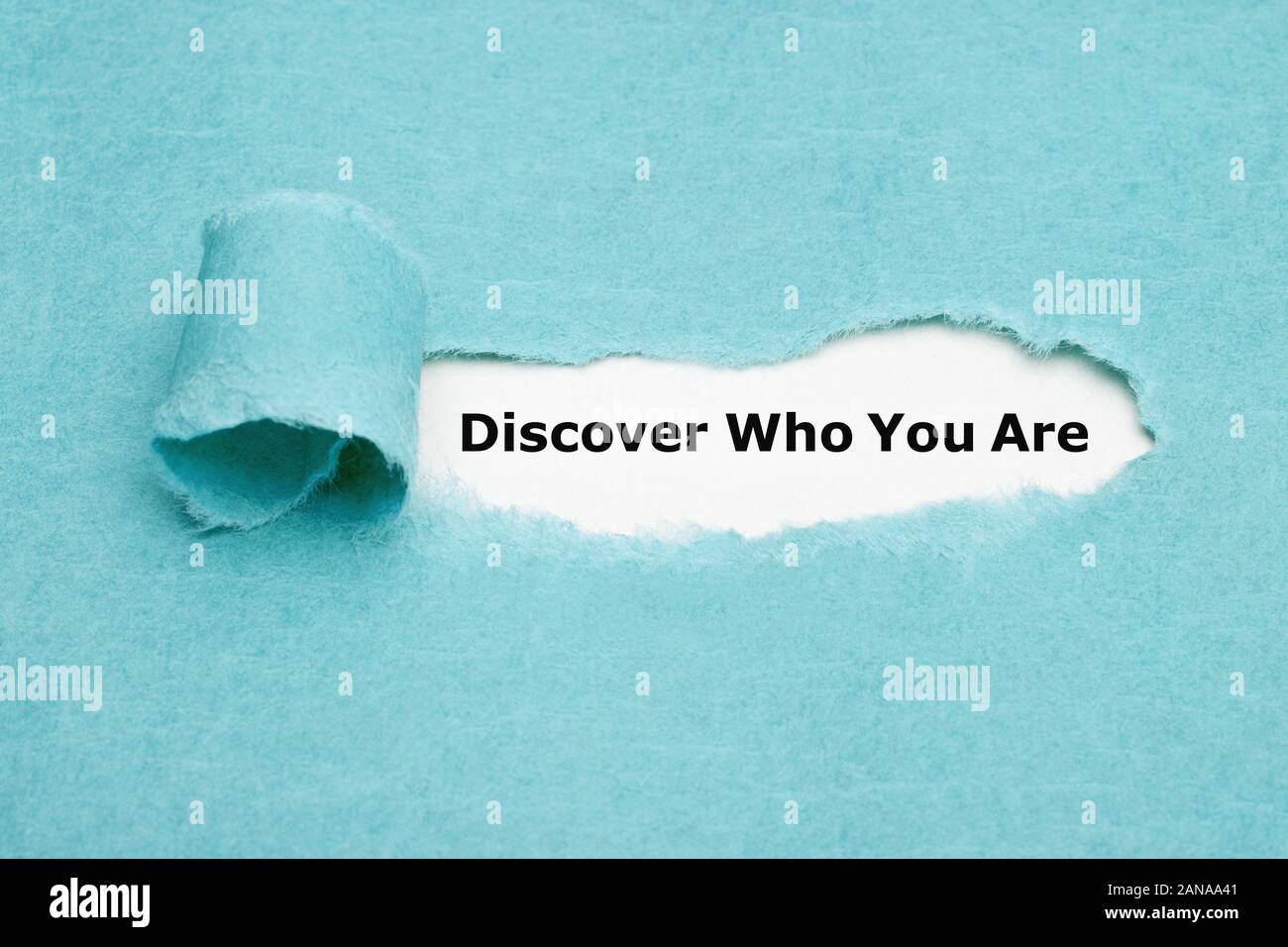 Text Discover Who You Are appearing behind torn blue paper. Finding yourself or personal development concept. Stock Photo