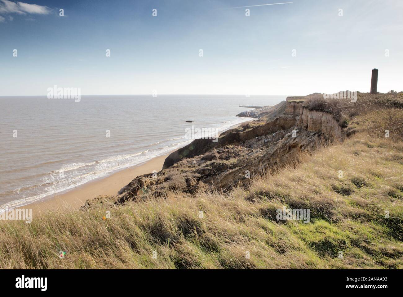 landscape image of the coastline at Walton-on-the-Naze in Essex with the naze tower in the background  where coastal erosion has dramatically eats at Stock Photo
