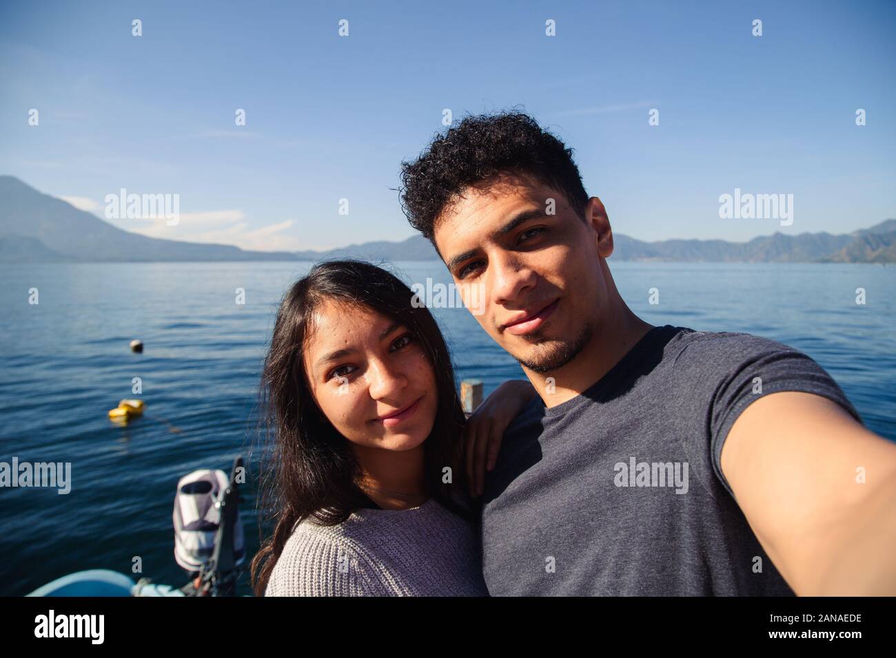 Traveling couple taking a selfie at Lake Atitlan in Guatemala Stock Photo