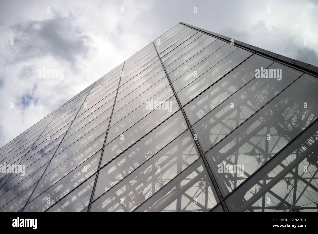 Illuminated glass pyramid at the Louvre, Paris. Louvre museum pyramid. the world's largest art museum and a historic monument Stock Photo