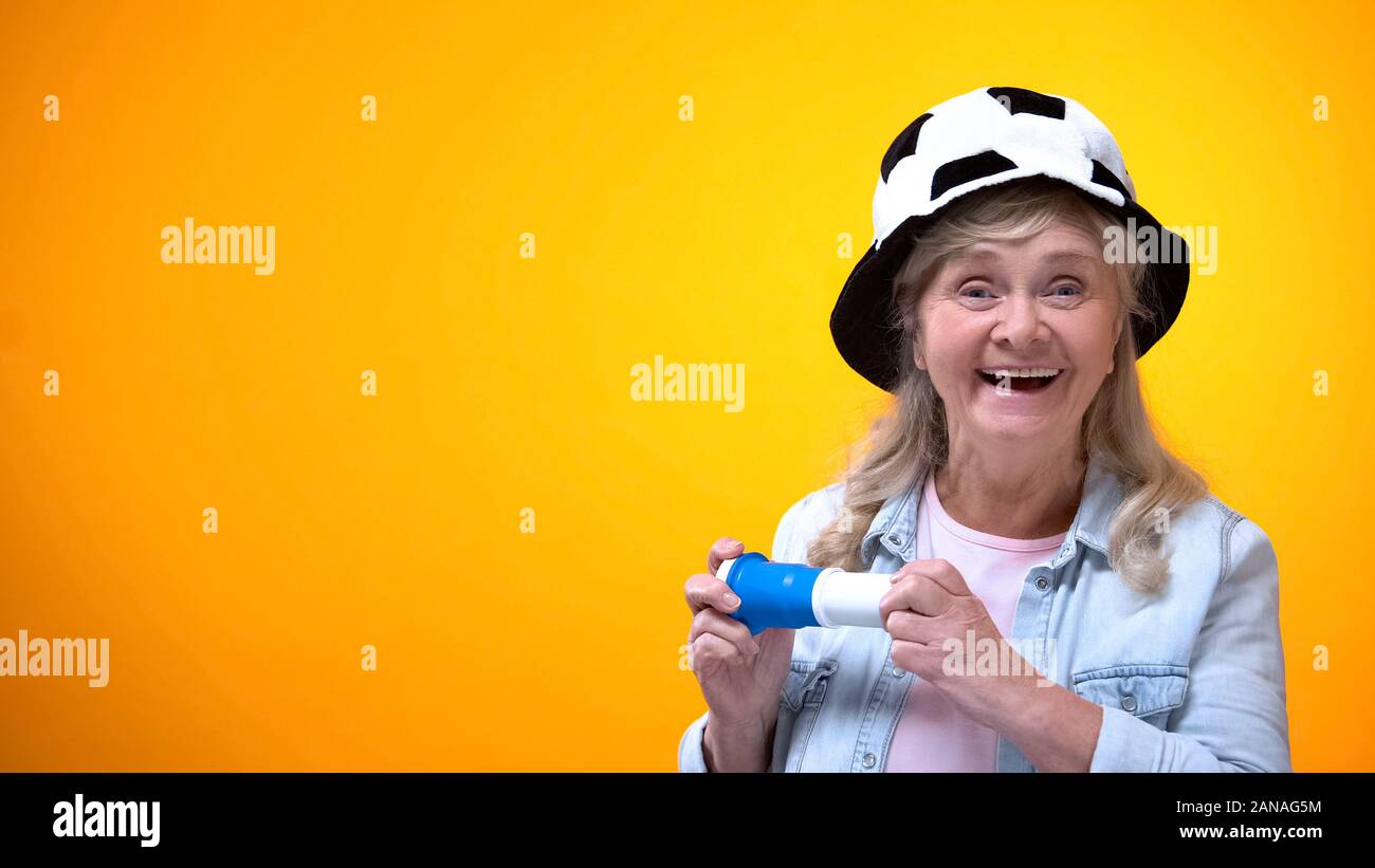 Extremely happy old lady supporting football team, sport betting, active life Stock Photo