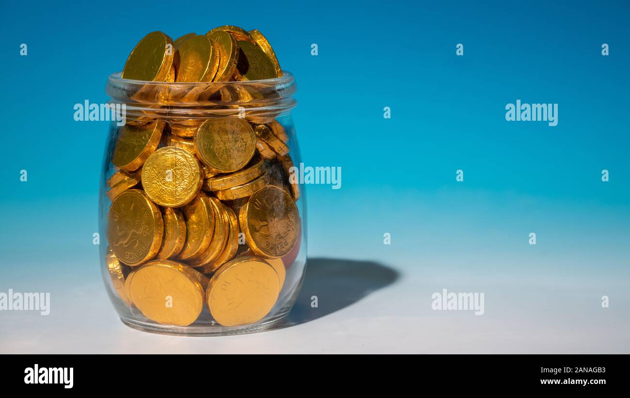 Glass jar full of gold coins Stock Photo Alamy