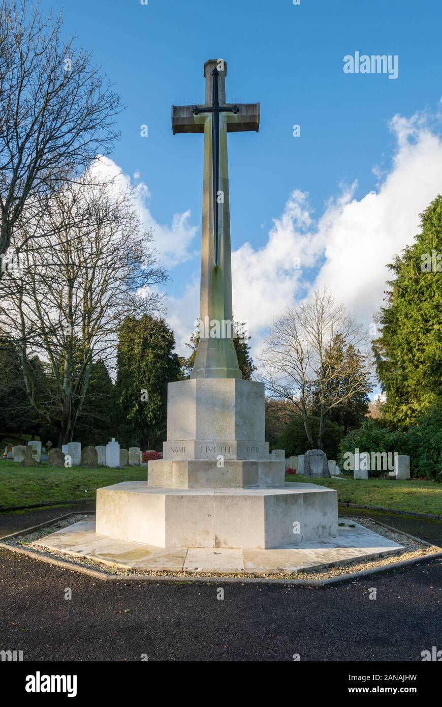 Cross of sacrifice on top of the hill with first world war graves at Aldershot Military Cemetery, Hampshire, UK. Stock Photo