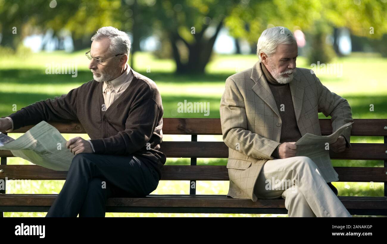 Two old men sitting on bench hires stock photography and
