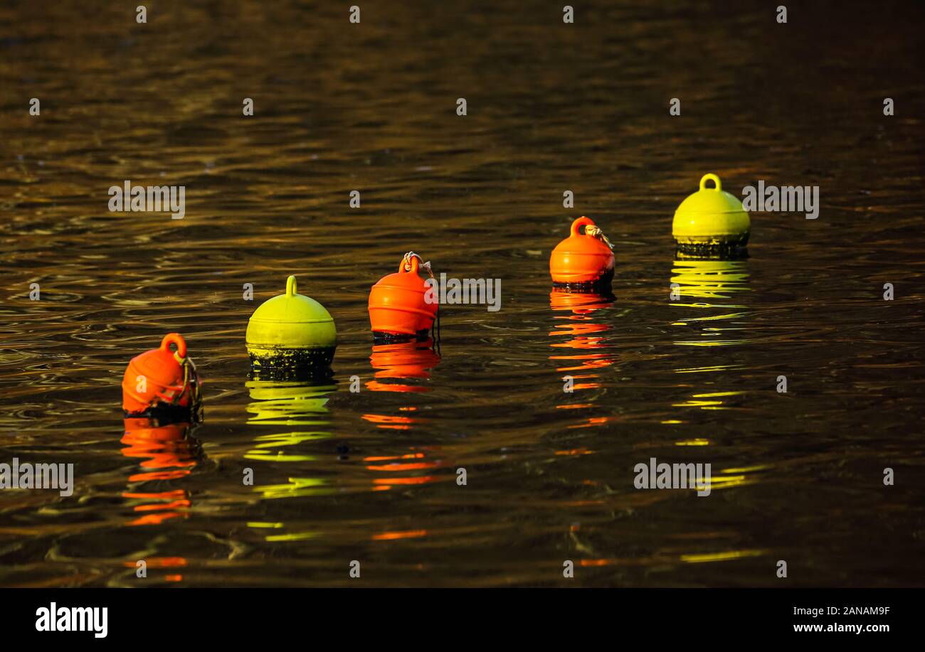 The bright colors of the buoys deserve even more attention in winter because they beautify the sometimes dreary weather. Stock Photo