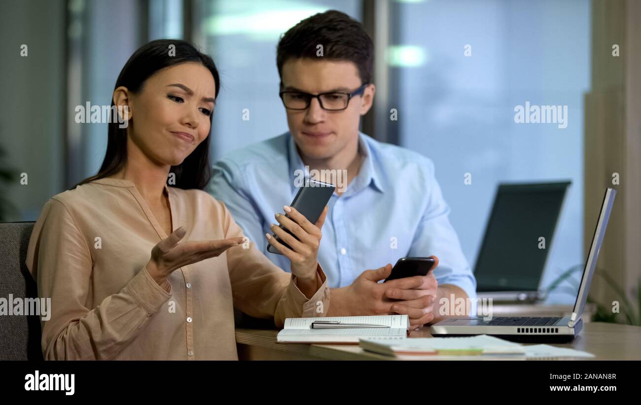Engineers testing new smartphone, disappointed with software quality, test group Stock Photo