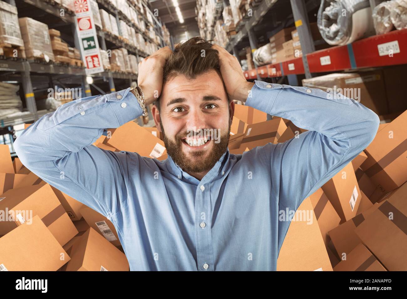 Man in a factory stressed about the many orders to be shipped Stock Photo