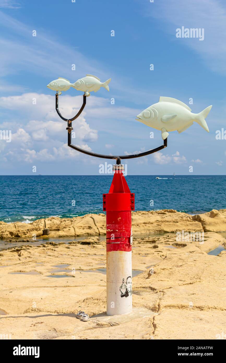 White and red weather vane with saddled breams at Exiles Beach, Sliema Stock Photo