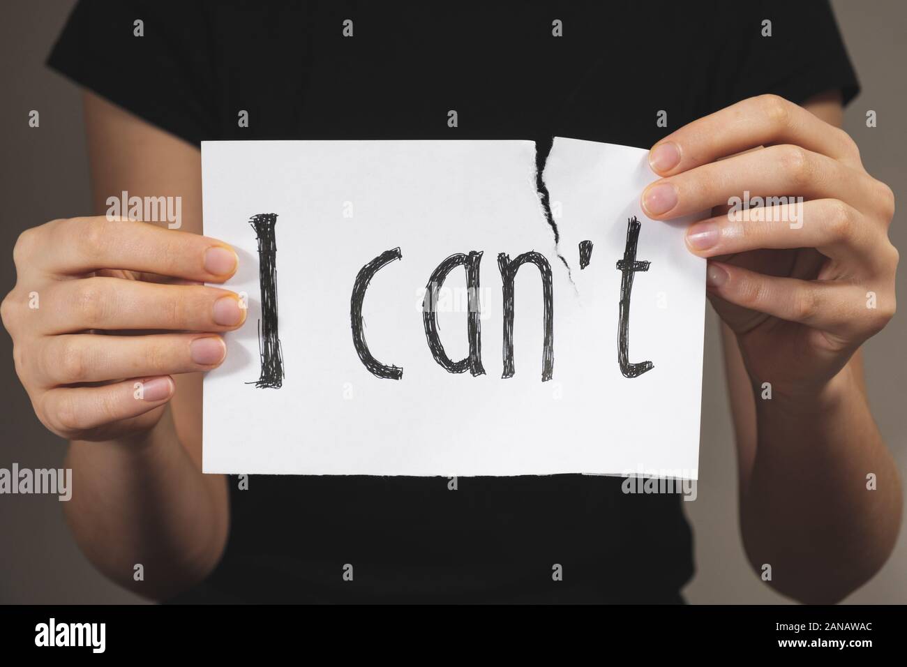 Hands tearing out negation of the 'i can not' sign. Motivational concept of believing in yourself and overriding problems and emotional difficulties Stock Photo