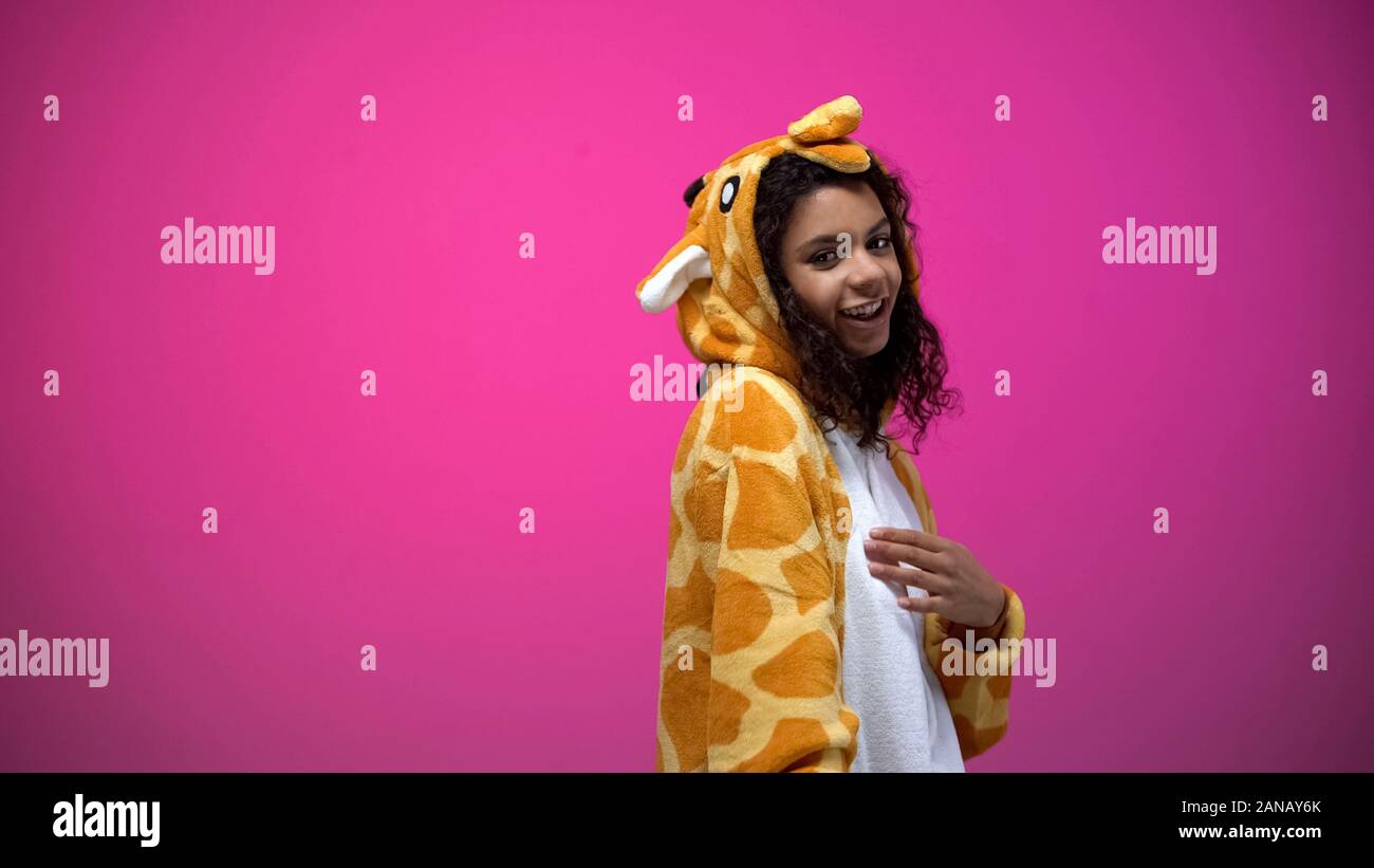 African american lady in funny giraffe costume posing on pink background, fun Stock Photo