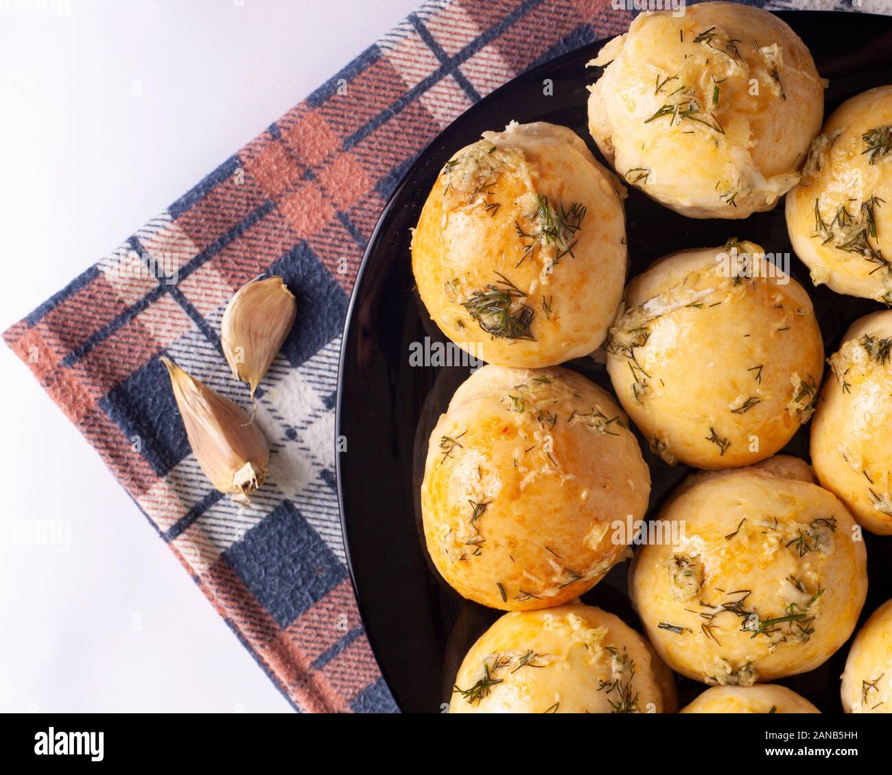 garlic baked goods .baked buns on a towel top view. Stock Photo